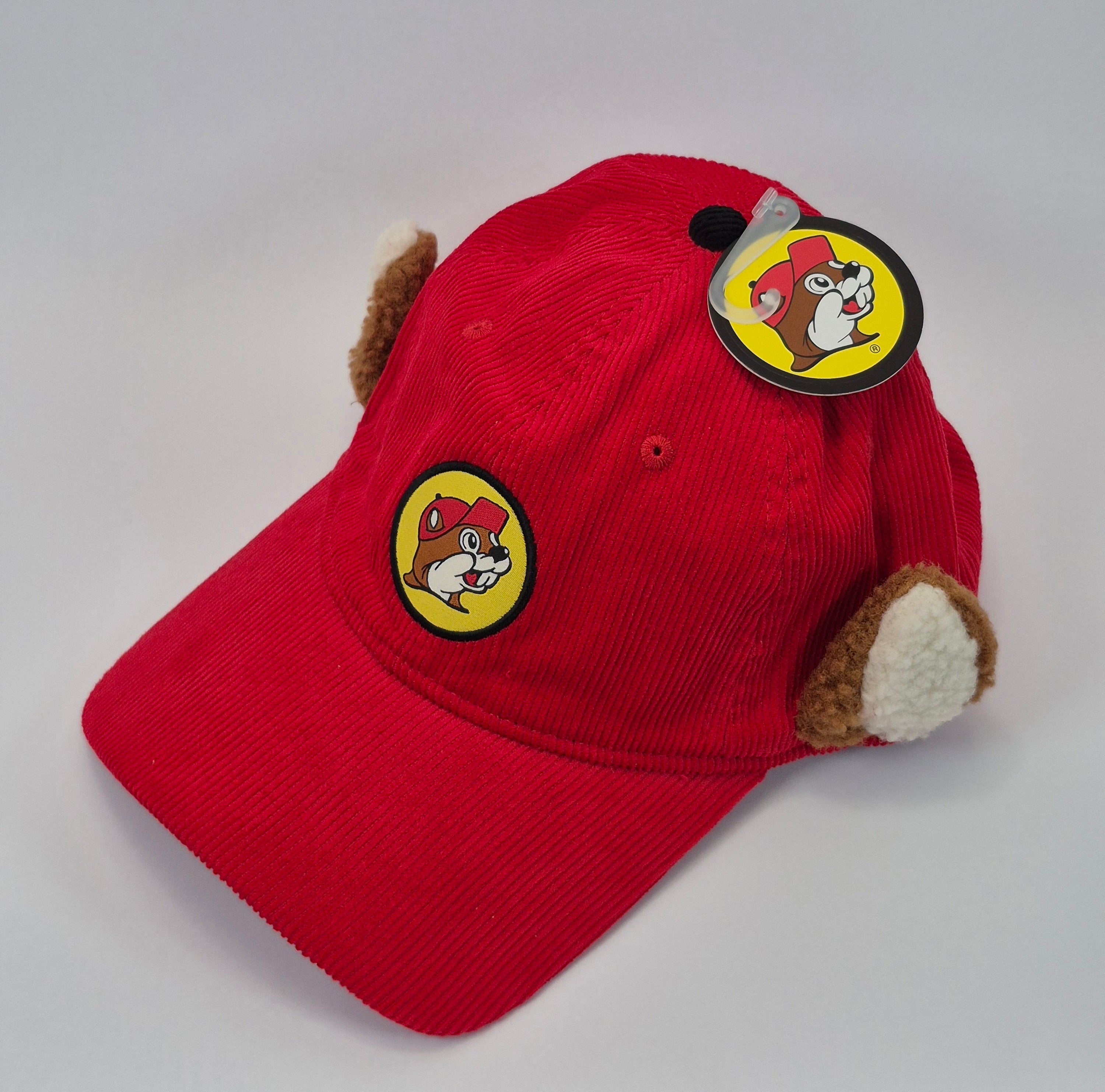 Red cap with bucees patch on a gray background