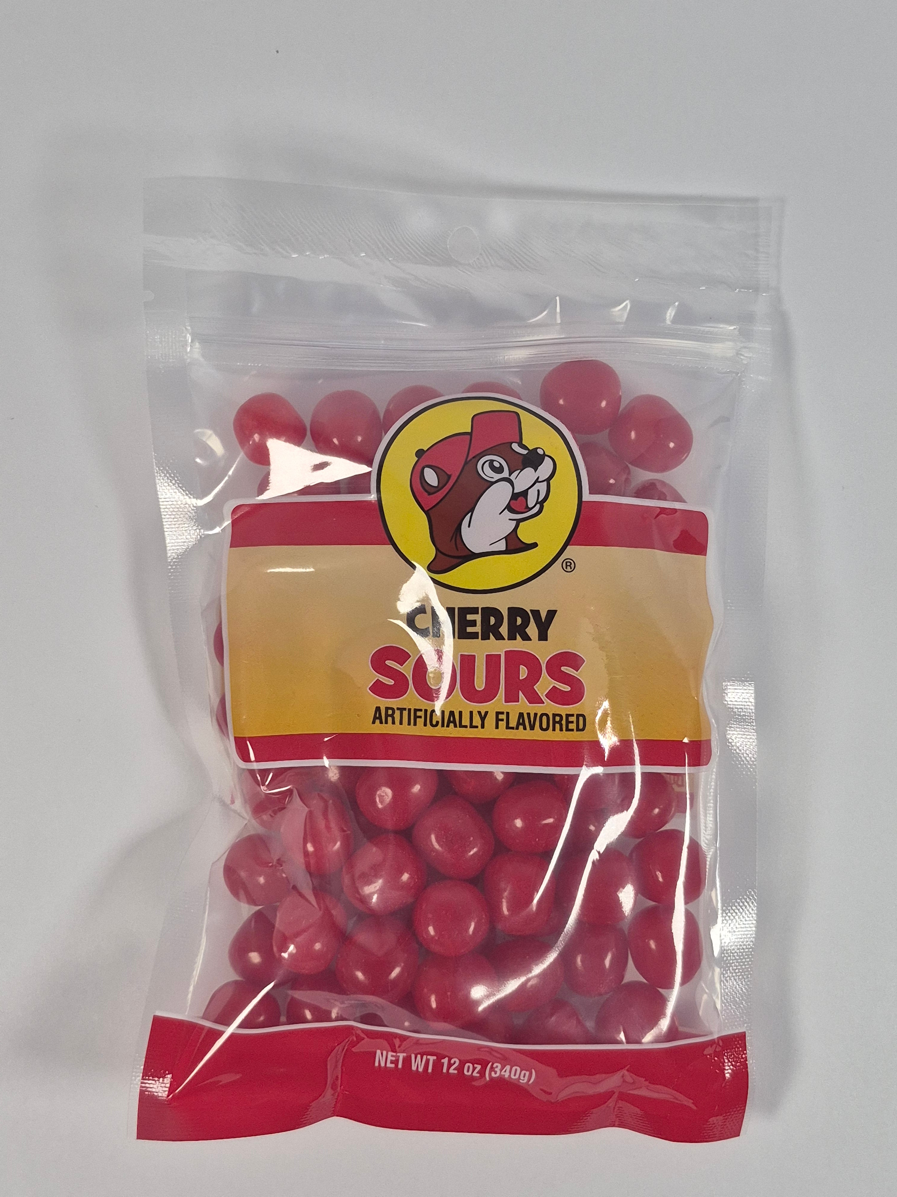 Bag of red jelly beans sour cherrys with a yellow label on a white background