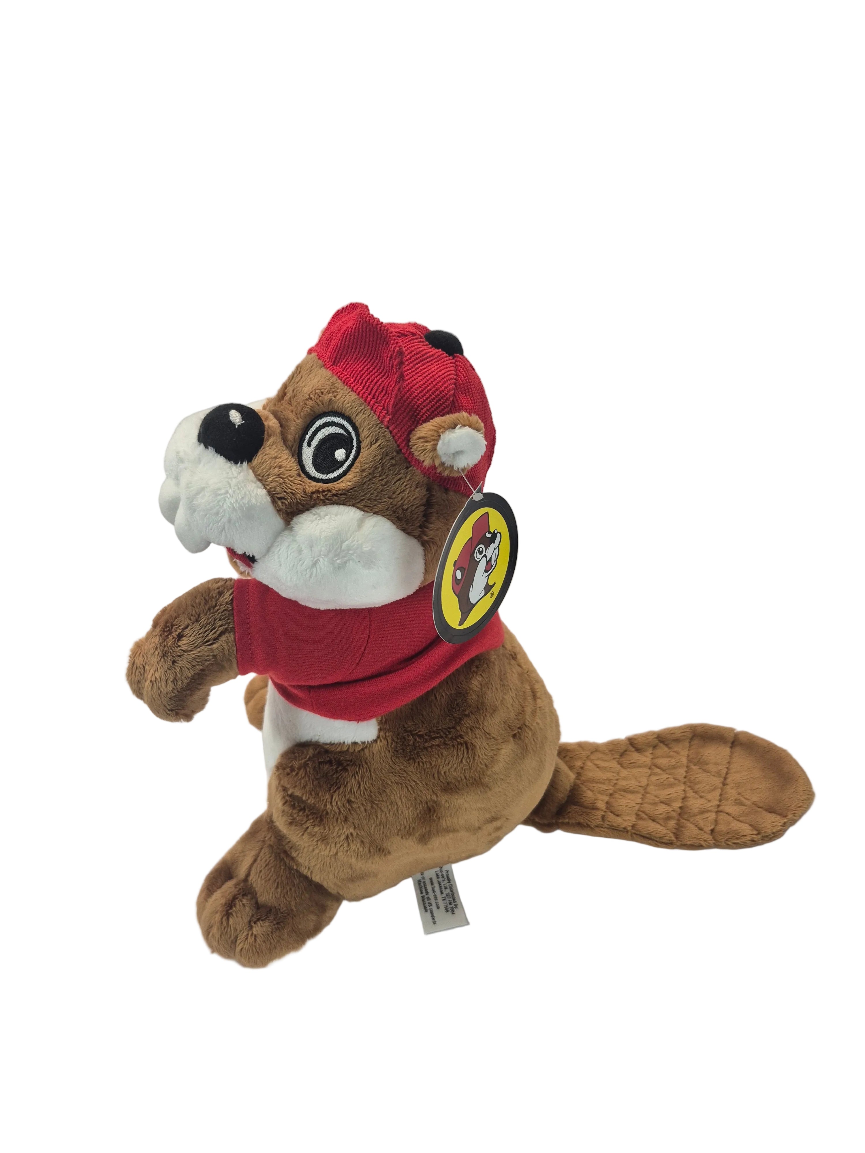 Plush toy beaver wearing a red outfit with a logo on a white background