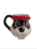 Mug shaped like a beaver's face with a red hat on a white background