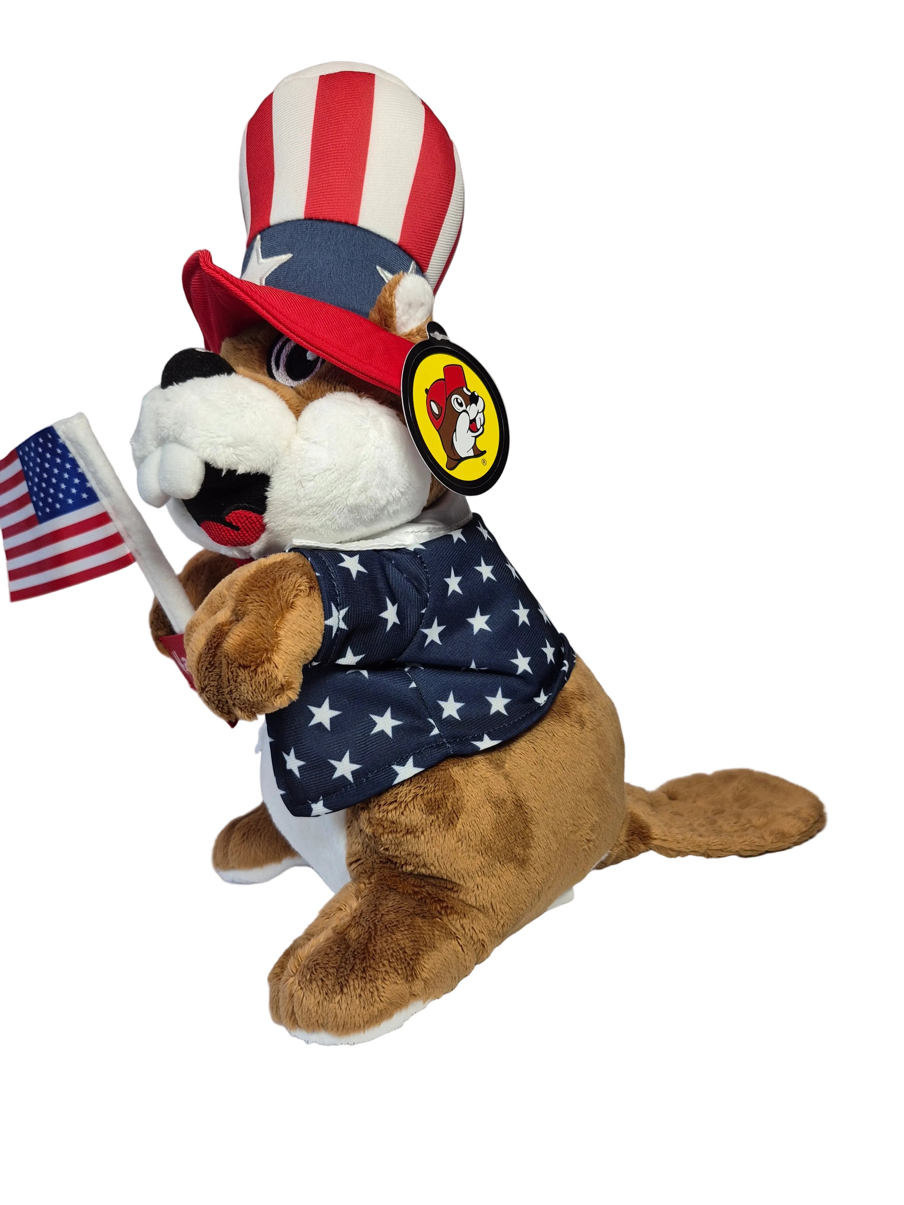 Plush dog toy wearing an American flag outfit with a hat and flag on a white background