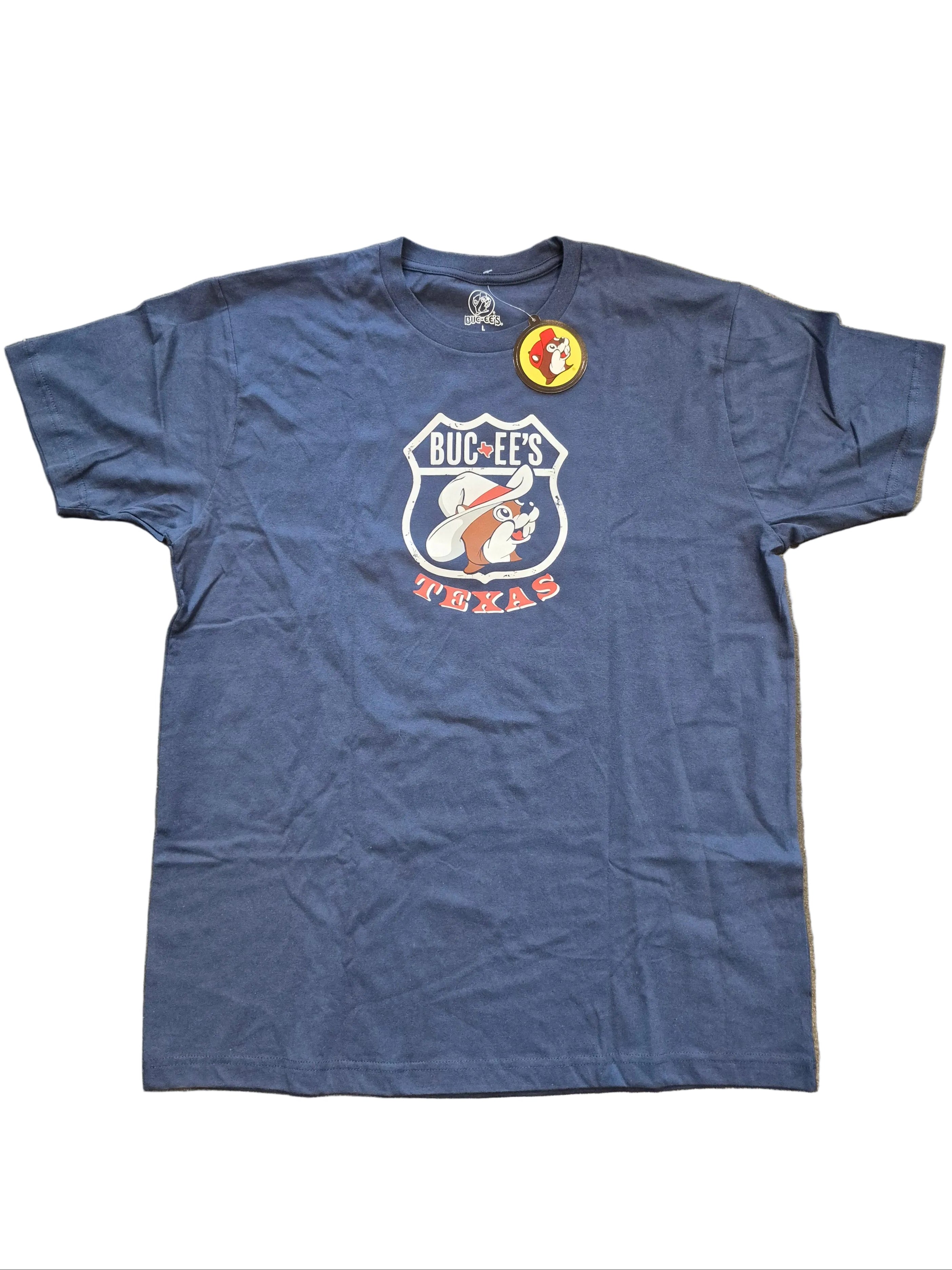 Blue t-shirt with a logo and text on a gray surface